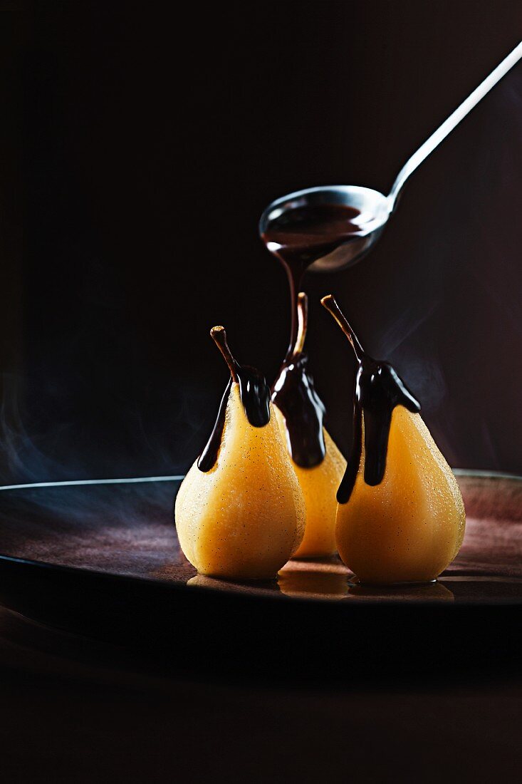 Poached orange and spiced pears with warm chocolate ganache