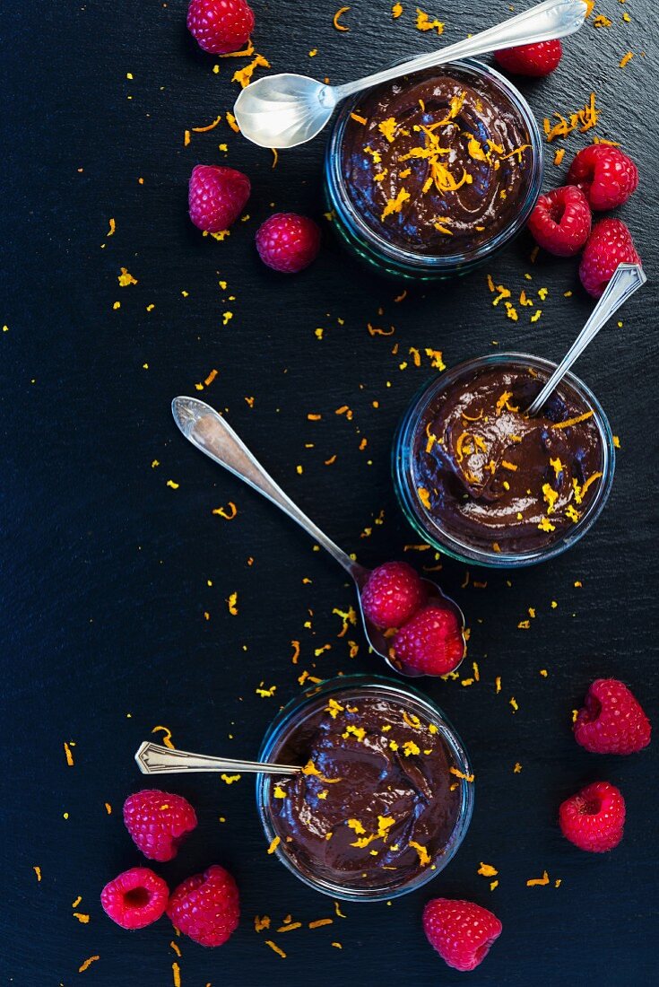 Vegan chocolate mousse with raspberries and orange zest