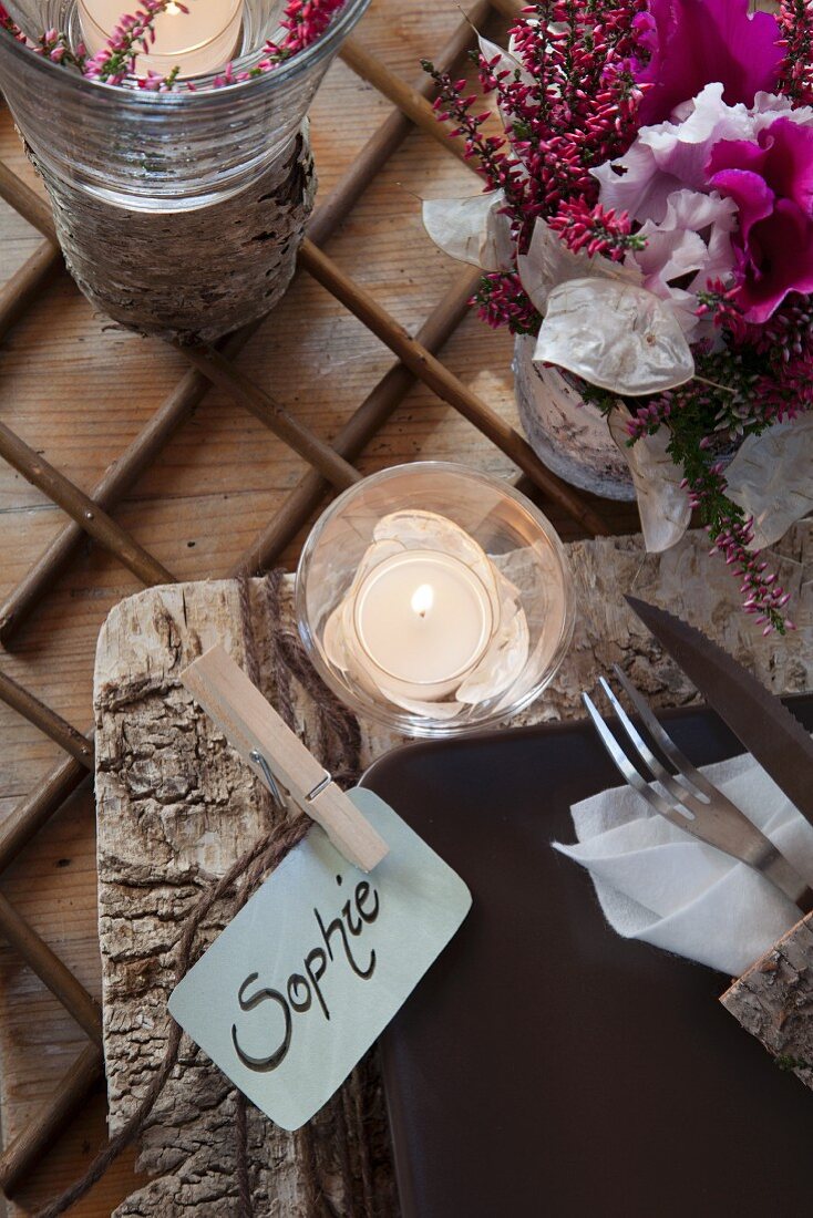 Birch bark place mat, name cards and lit tealight