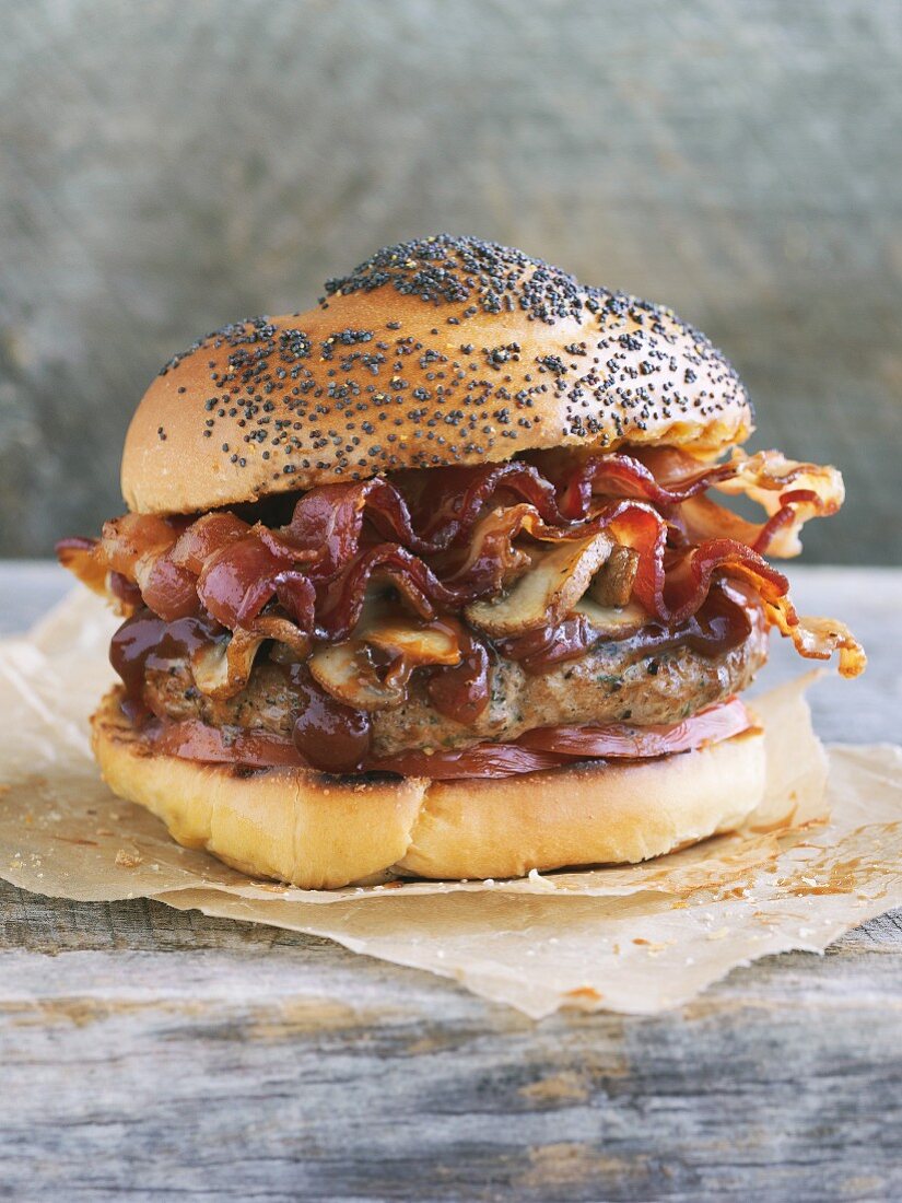 A hamburger with bacon and mushrooms