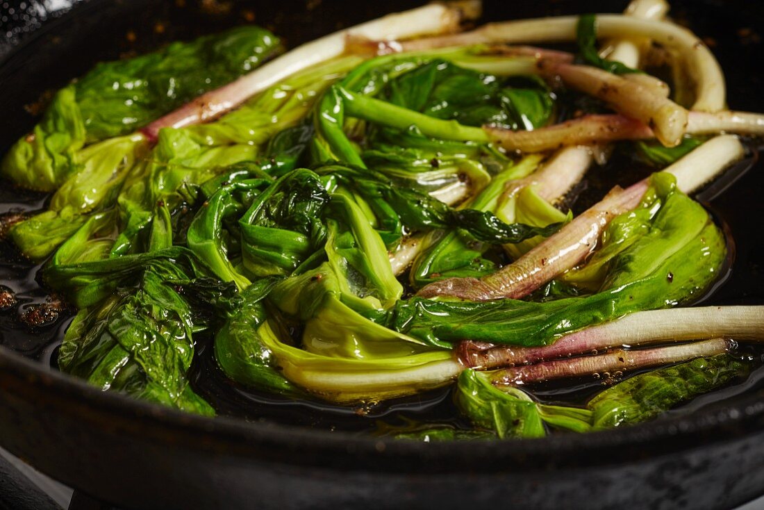 Fried wild leeks in a pan (close-up)