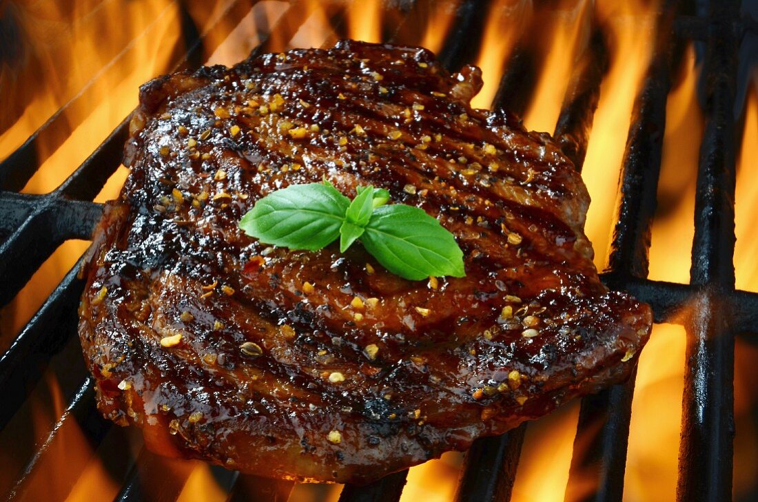 Rib eye steak on a flaming grill