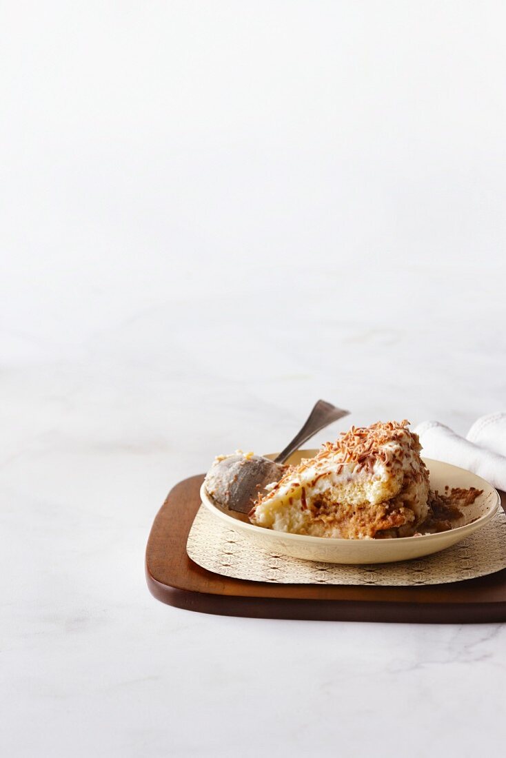 A portion of tiramisu on a dessert platter