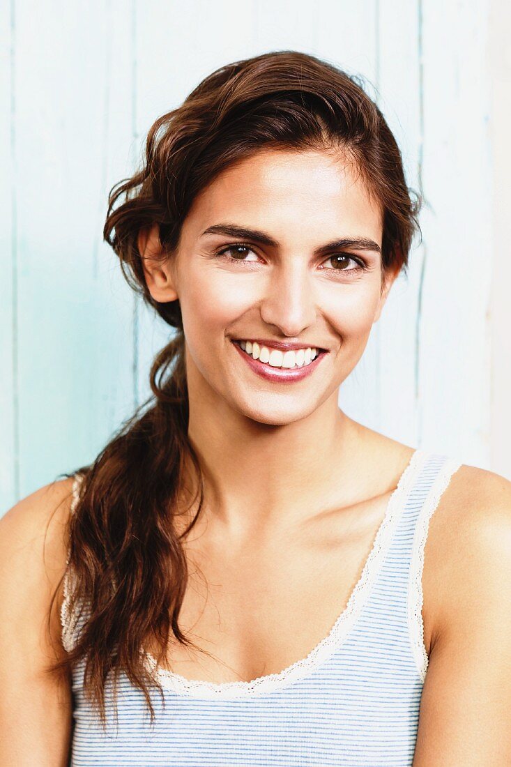 Young brunette woman wearing striped vest with lace trim