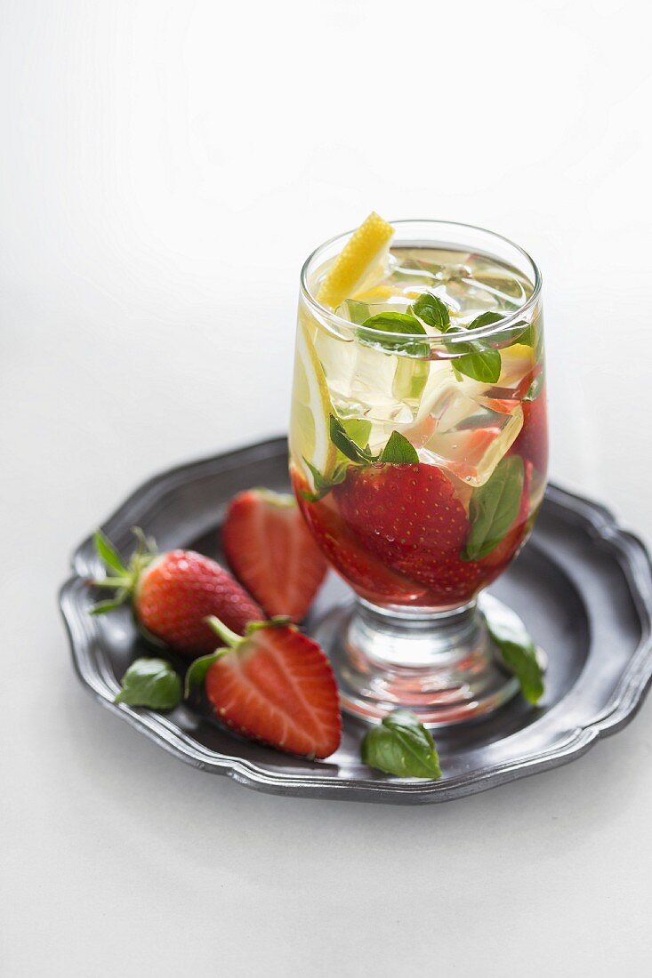 Water flavoured with strawberries, lemon and basil