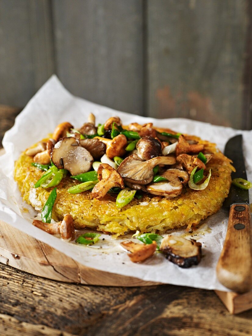 A potato cake topped with mushrooms