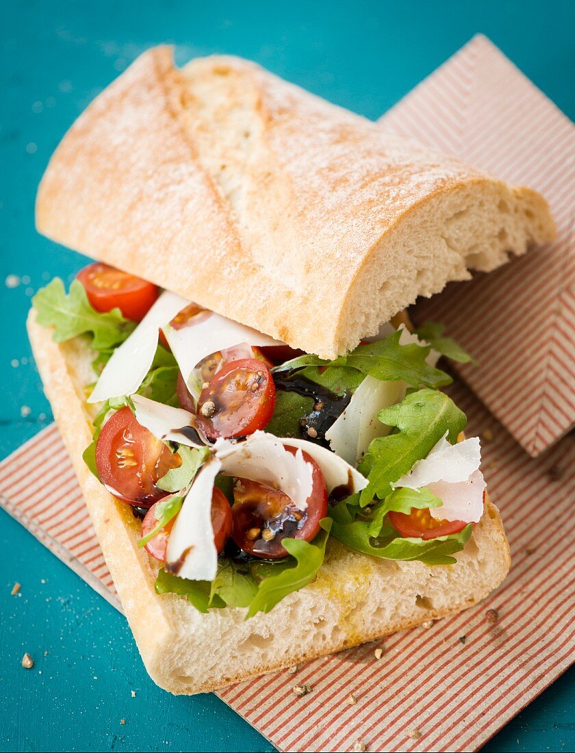 Ciabatta sandwich with rocket, tomatoes and Parmesan cheese