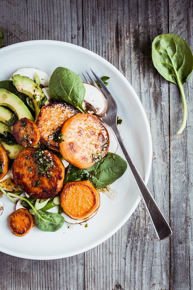 Sweet potato salad with avocado and baby spinach