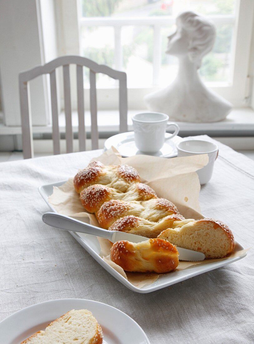 Plaited quark bread with sesame seeds, sliced