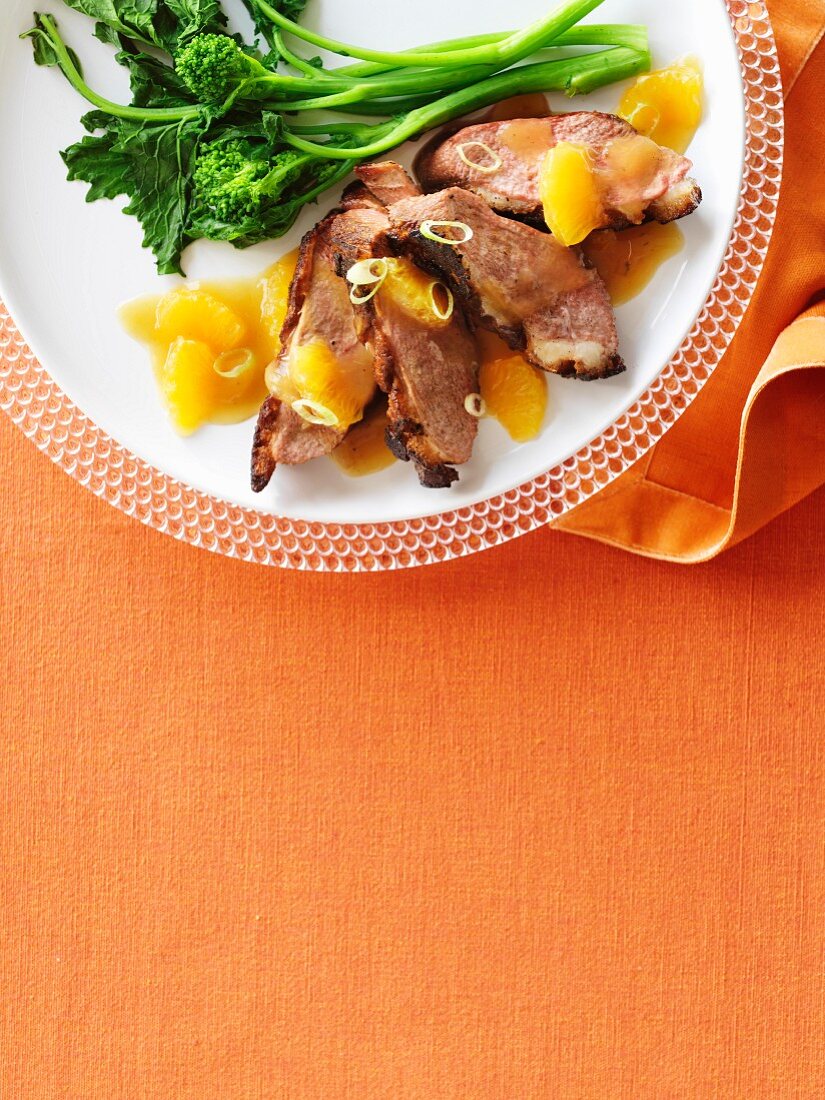 Crispy grilled duck breast with orange sauce and rapini