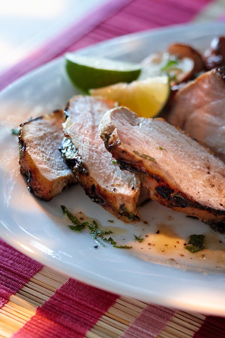 Grilled pork steak with a lime and mint sauce