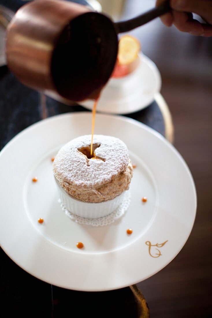 Caramel being poured over a soufflé, Lapérouse, Paris