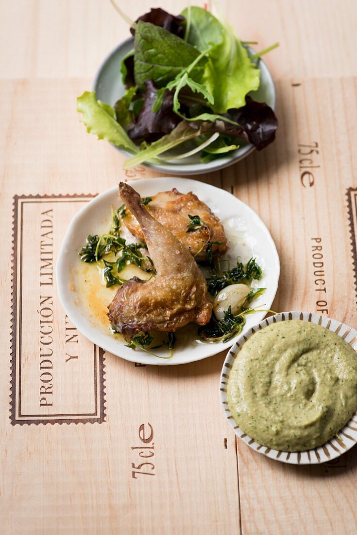 Roasted quail with a herb dip and a salad