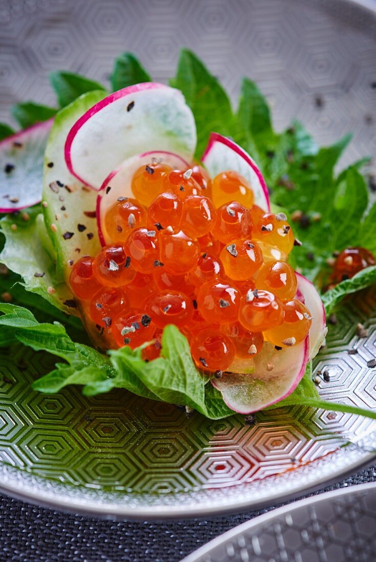 Salmon caviar and radishes on shiso leaves