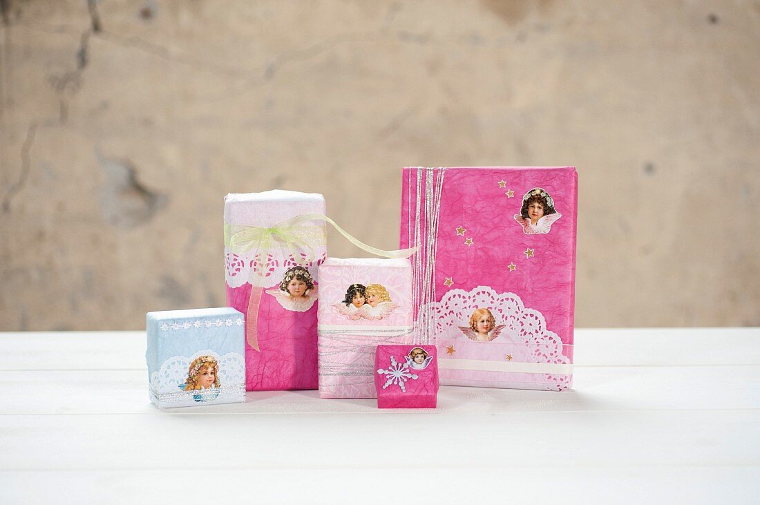 Christmas gifts wrapped in romantic vintage style with cherub motifs and lacy doily trim