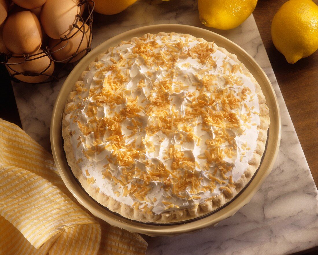 Lemon pie with a meringue topping and grated coconut