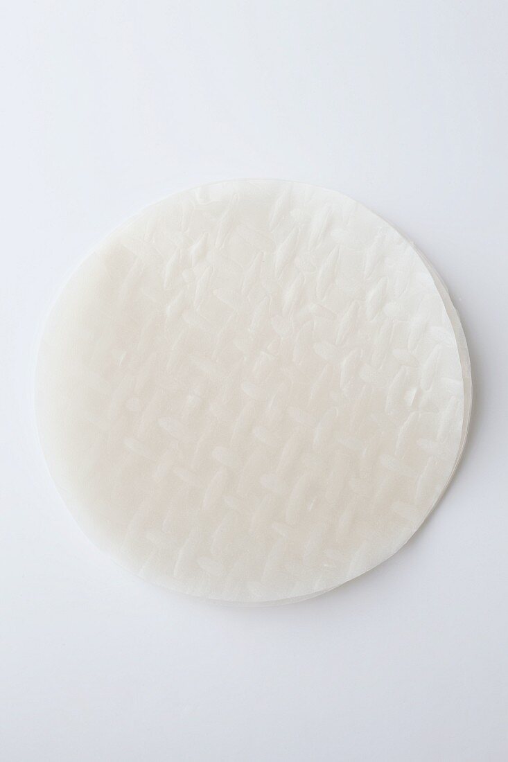 A round sheet of rice paper on a white surface