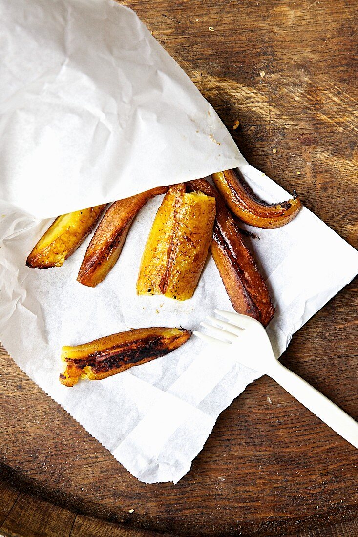 Grilled plantains in a paper bag