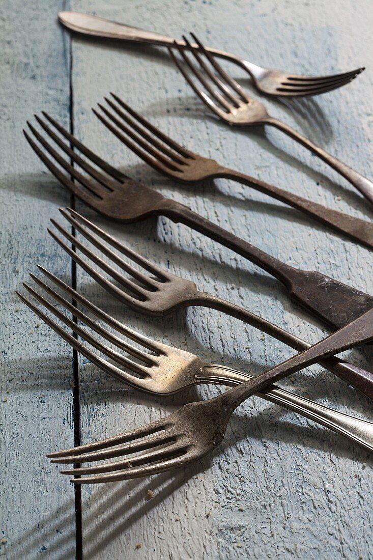 Old forks on a wooden surface