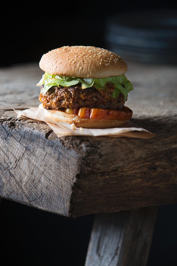 A grilled hamburger on a wooden table