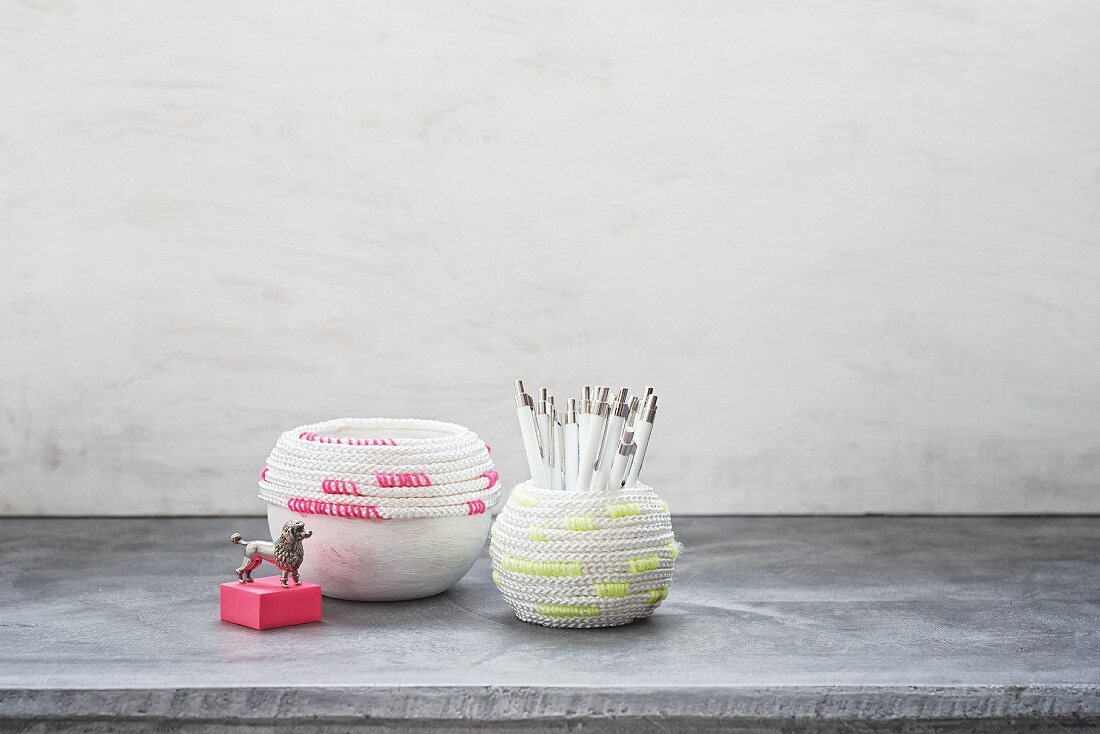 Pots wrapped in neon cords used as pen holders