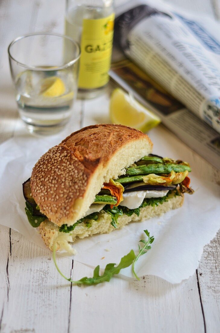 A vegetarian sandwich with grilled vegetables, mozzarella and courgette flowers