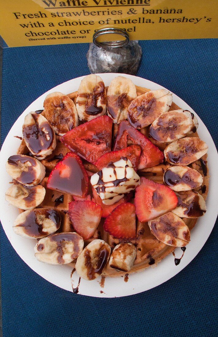 Waffles with strawberries, bananas and chocolate sauce (Mexican street food in Los Angeles, USA)