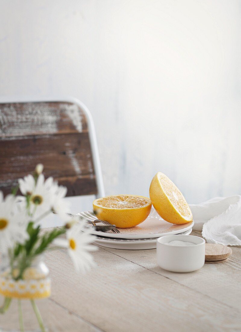 A halved lemon on a stack of plates