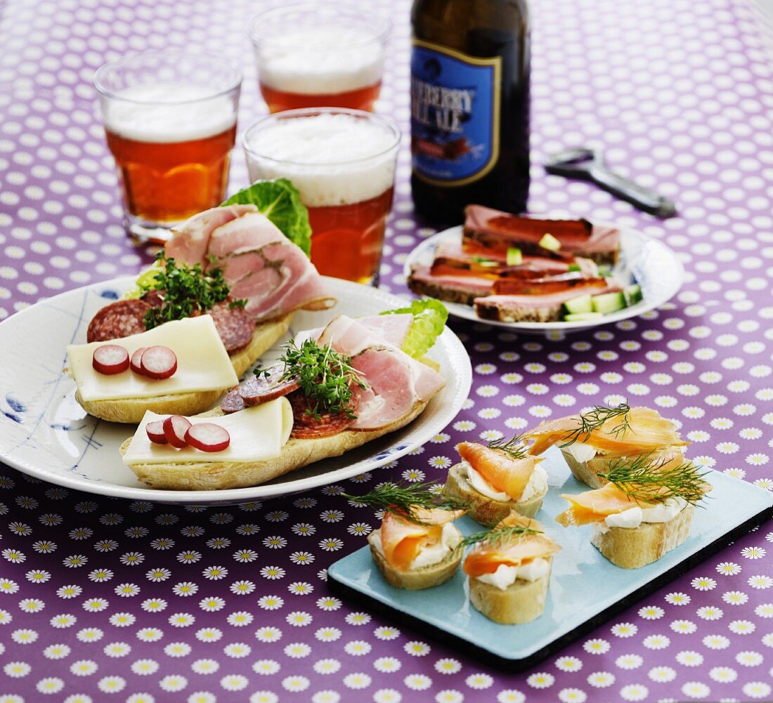Various open sandwiches with beer