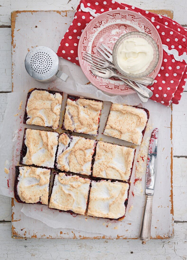 Sliced blackberry cake with meringue