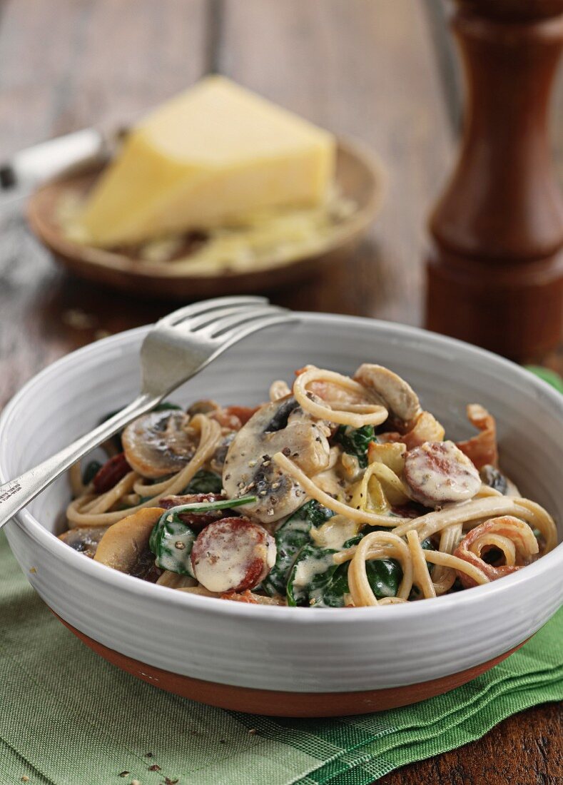 Spaghetti carbonna with sausage, mushrooms and spinach