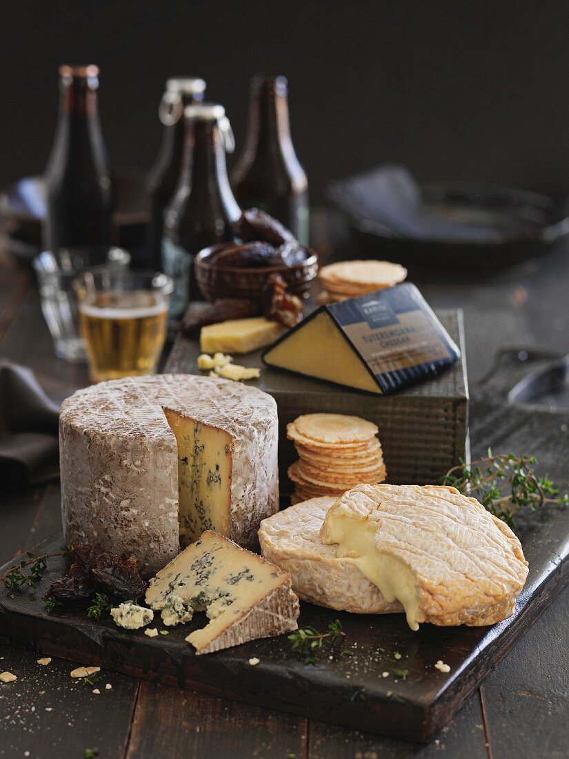 Various types of cheese, crackers and beer