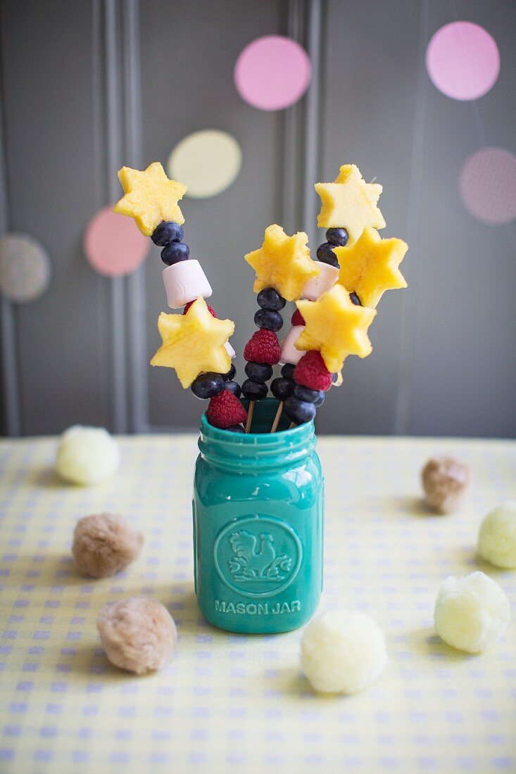 Fruit magic wands with pineapple stars, marshmallows, blueberries and raspberries