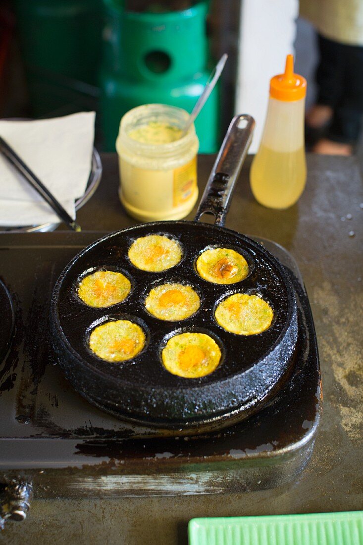 Mini eggs being fried in a pan (Vietnam)