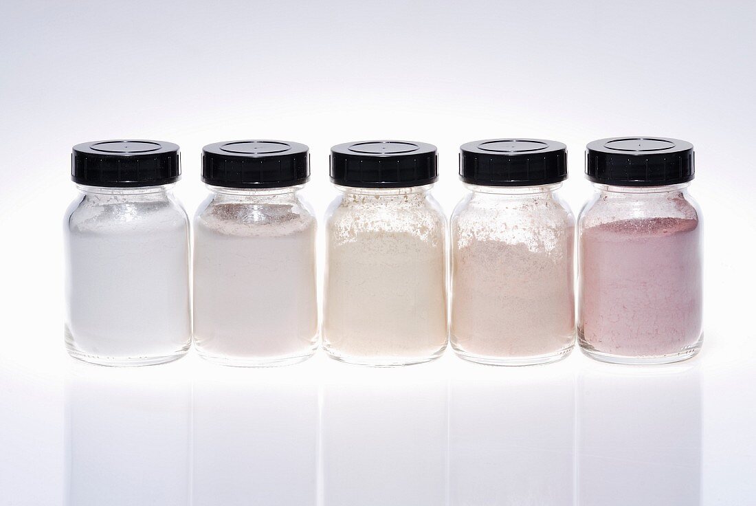 Small jars of light-coloured make up