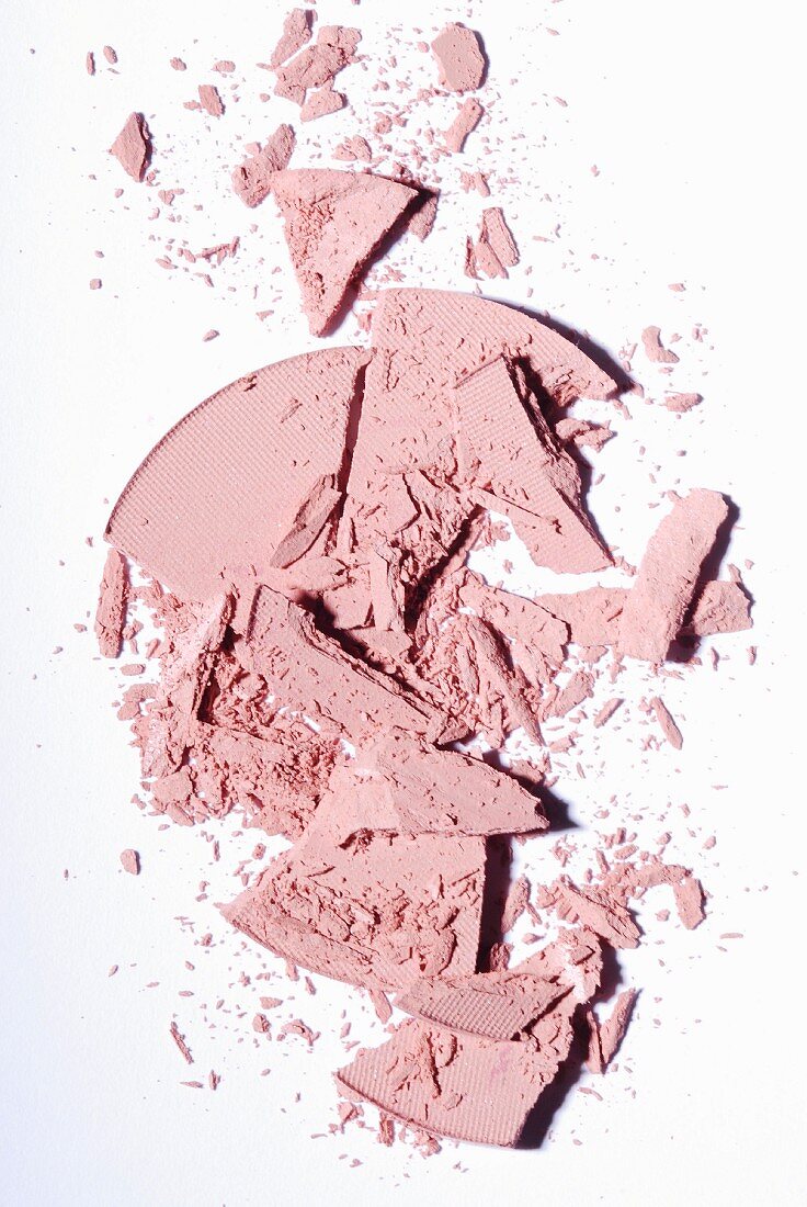 Powdered rouge crumbled on a white surface