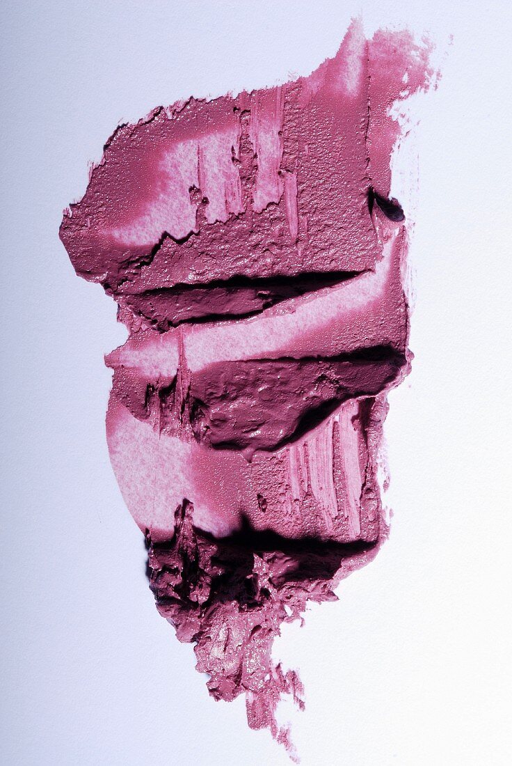 Pink lipstick spread on a white surface