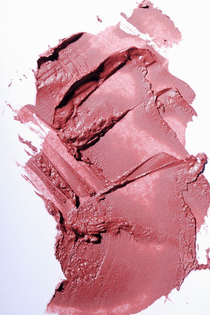 Old-rose lipstick on a white surface