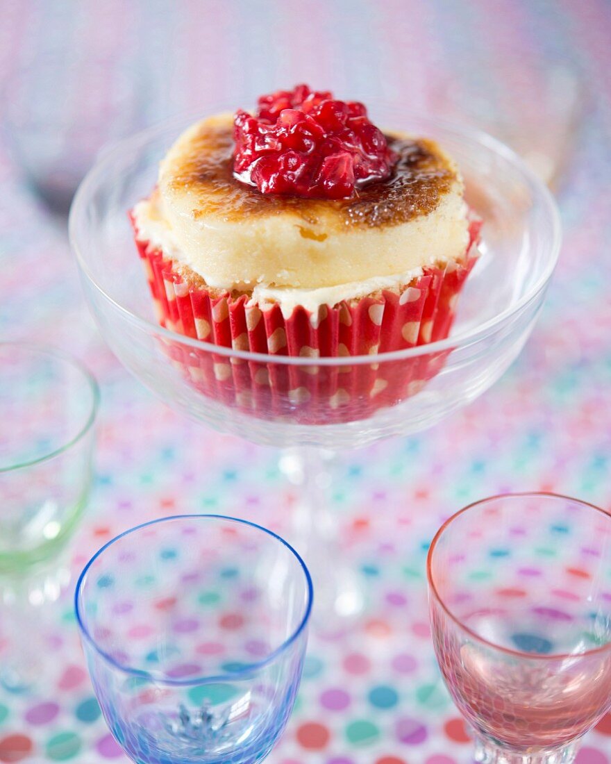 A crème brûlée cupcake with mashed raspberries