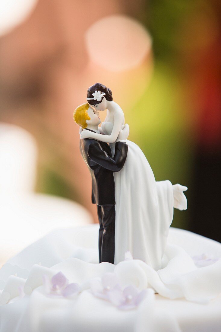 A porcelain bride and groom on a wedding cake