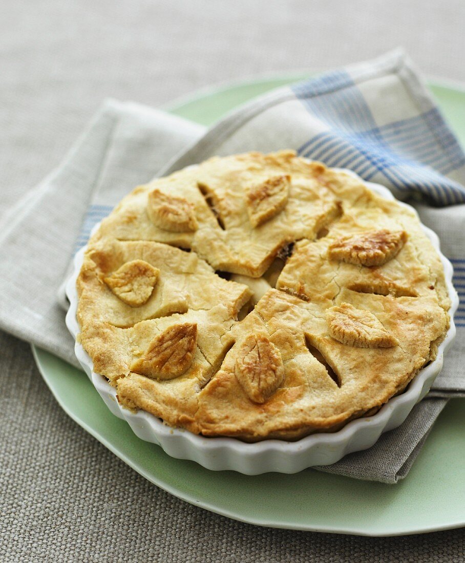 A pie decorated with pastry leaves
