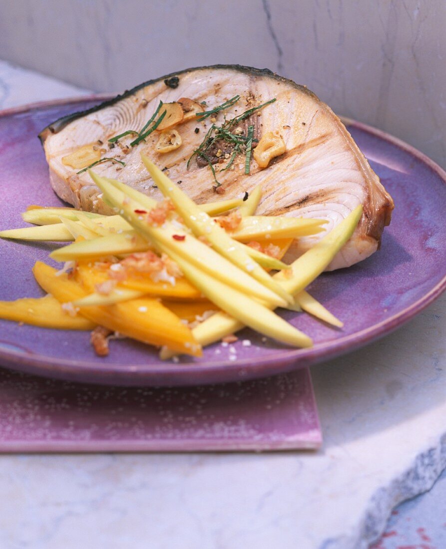 Grilled swordfish steak with a mango salad
