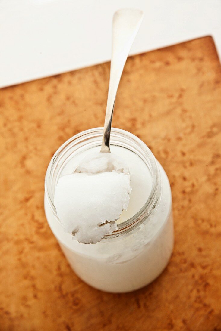 Coconut oil in a jar and on a spoon