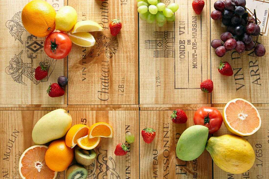 Various fruits and tomatoes on wine crates
