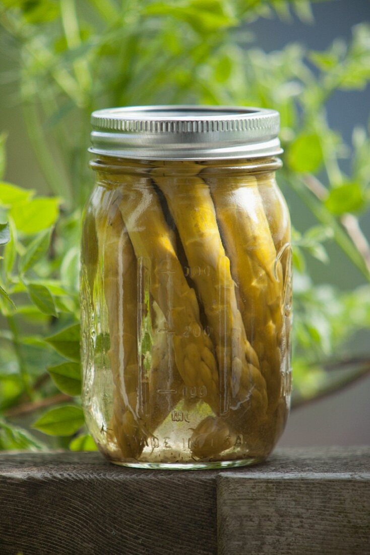 Pickled green asparagus in a screw-top jar