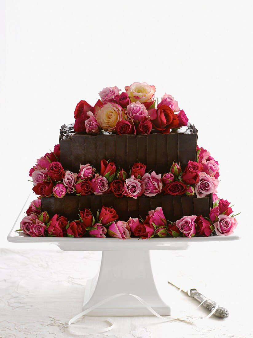 A two tier chocolate cake decorated with rosebuds