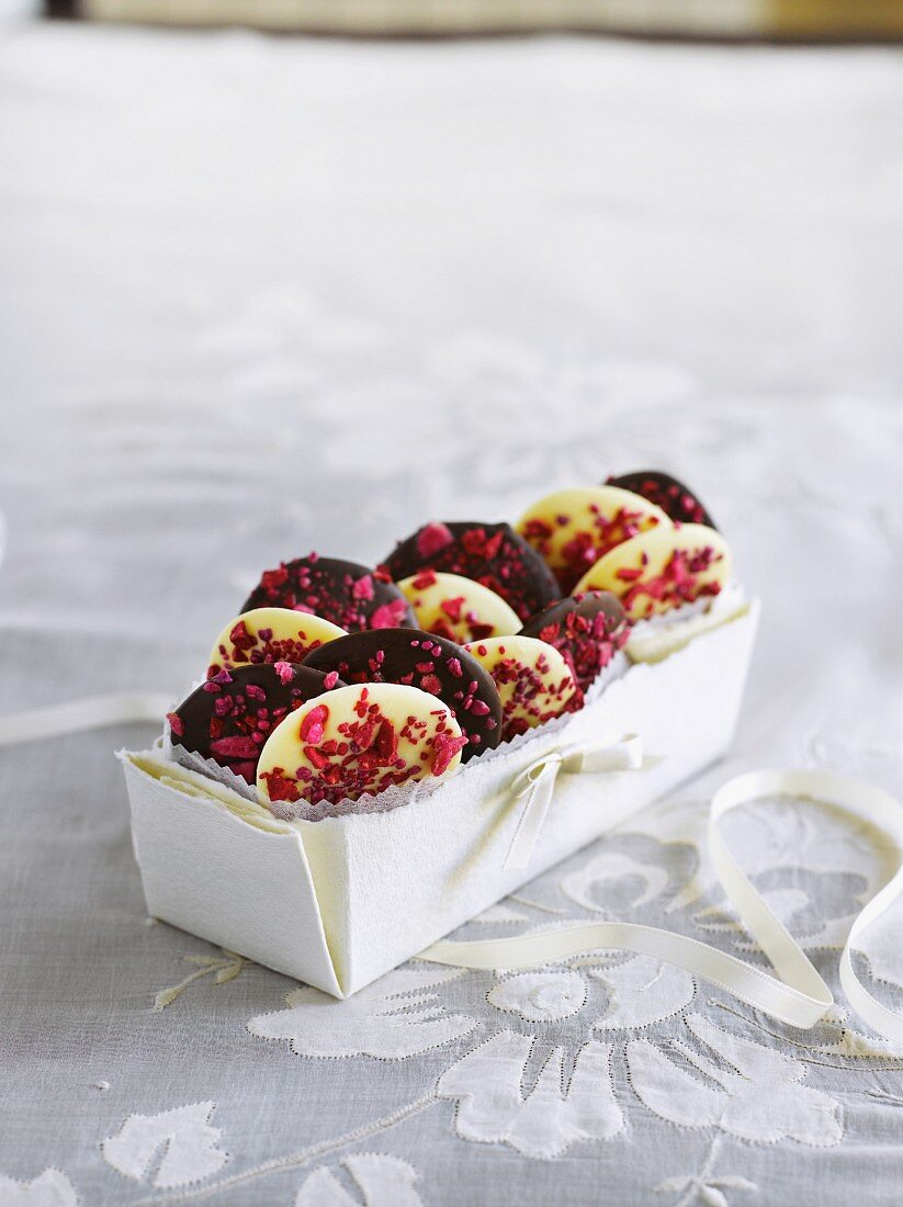 Chocolate wafers with raspberries and roses in a gift box