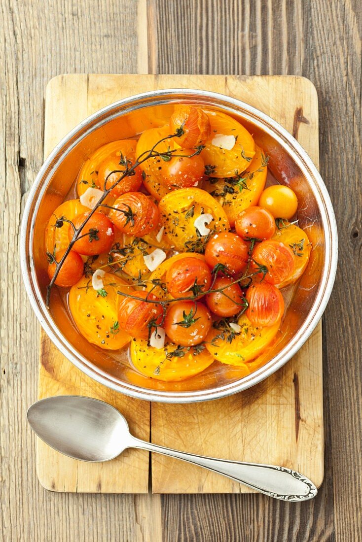 Baked yellow tomatoes and cherry tomatoes with thyme, garlic and olive oil