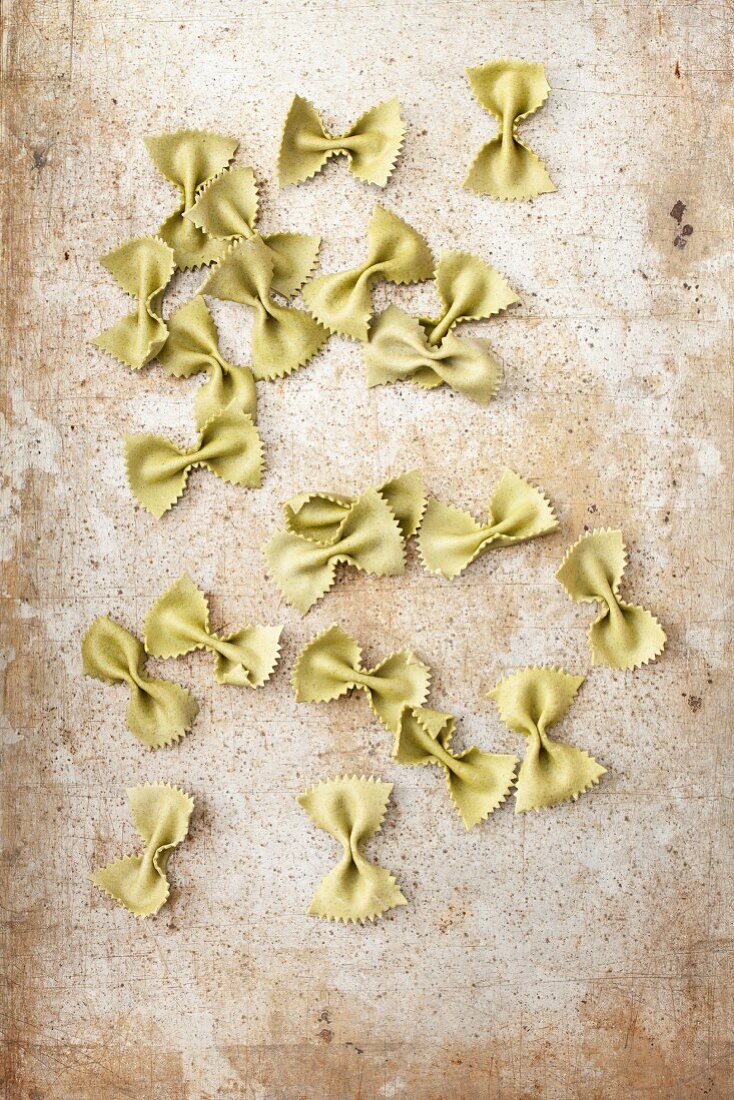 Spinach farfalle on metal surface