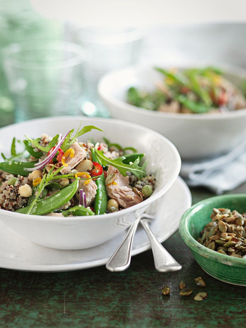 Quinoa salad with mange tout, rocket, fish, chickpeas and chilli